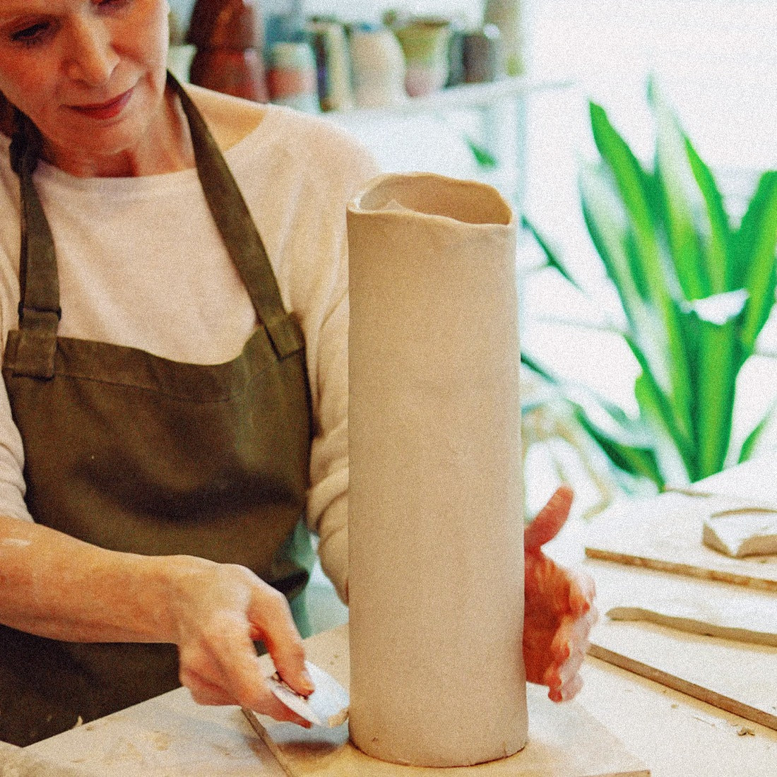 Artist refining sculptural piece in clay studio