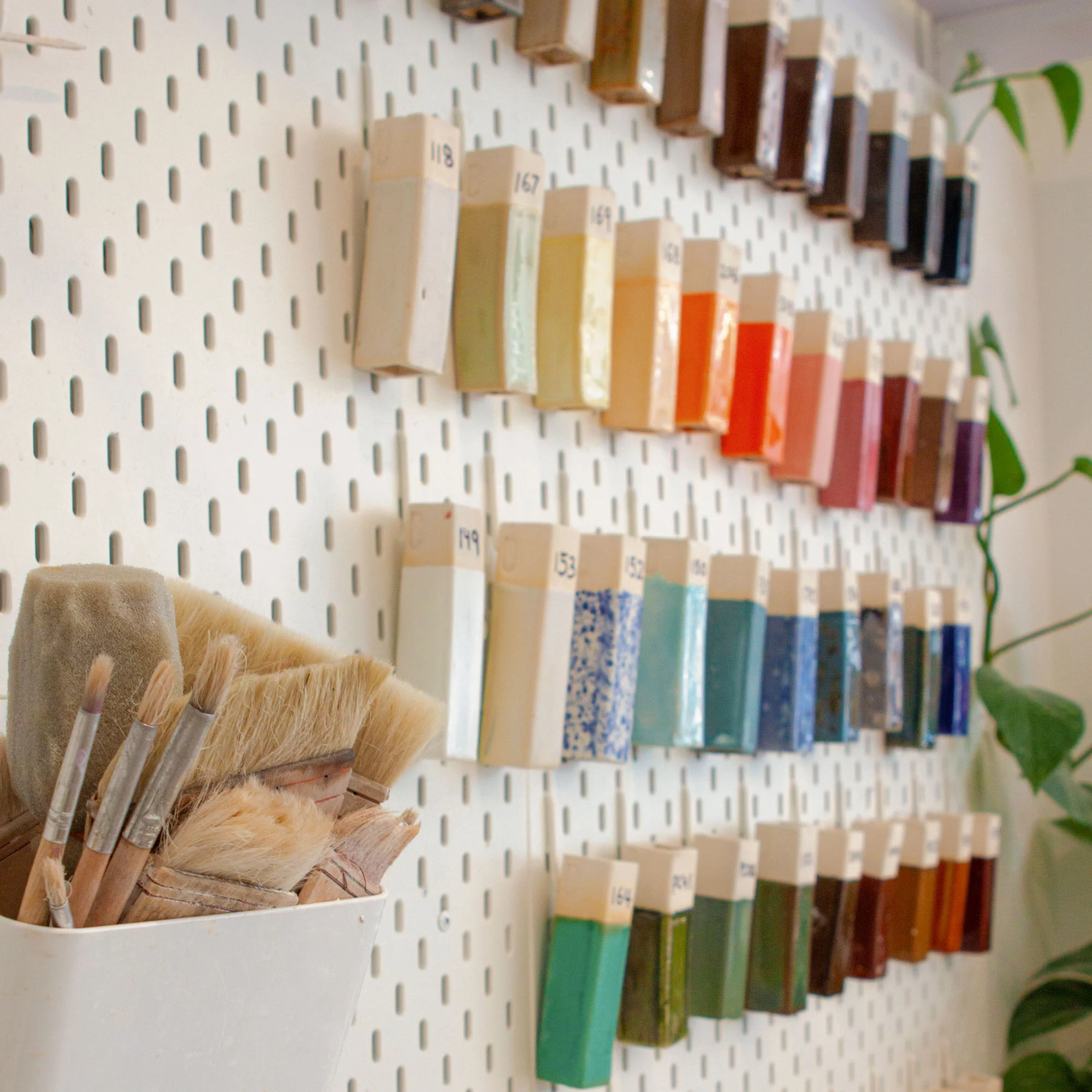 Display of colorful kids' pottery projects