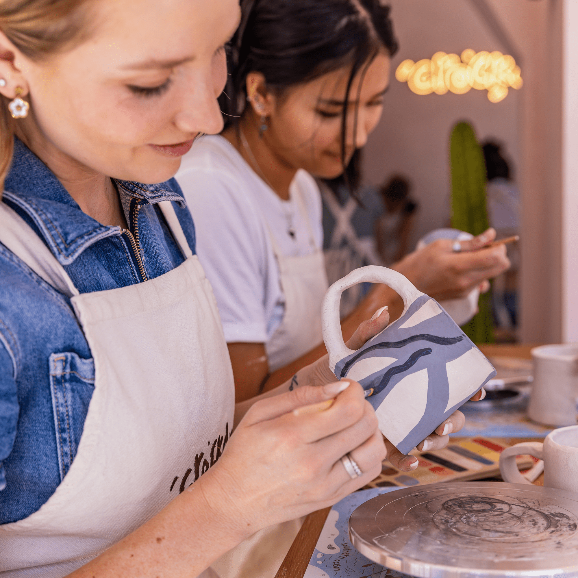 Participant selecting pottery piece to paint