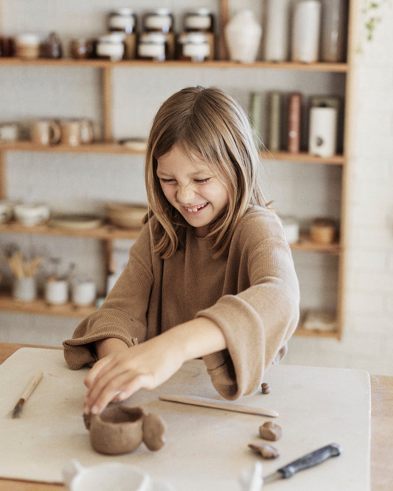 Instructor demonstrating mug-making techniques