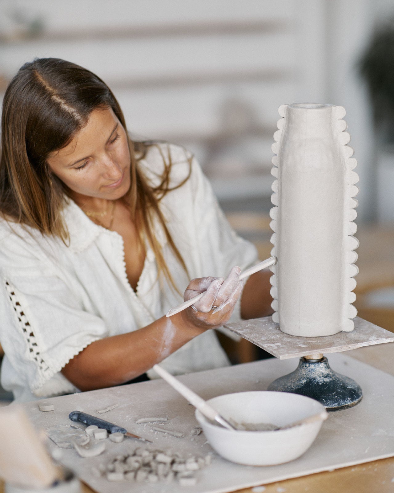 Students glazing their hand-built pottery creations