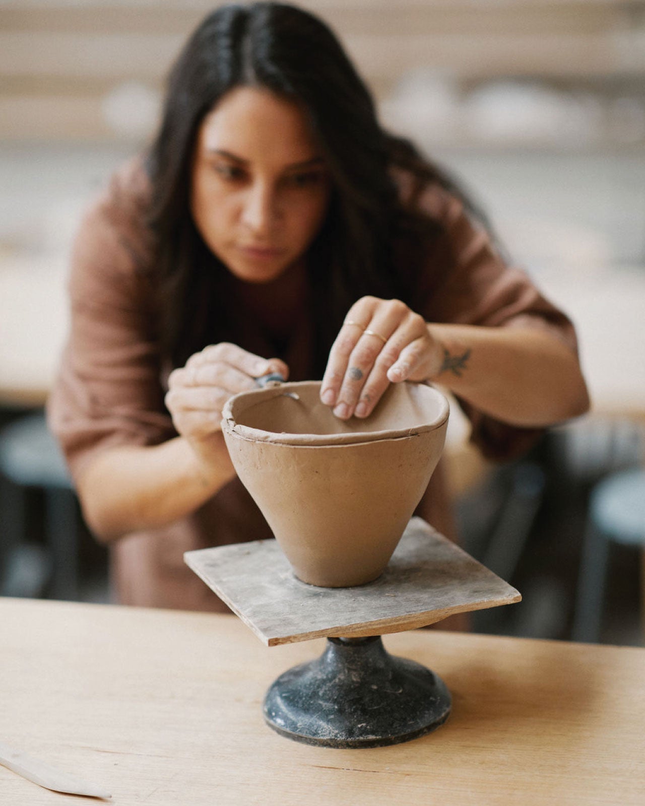 Beginners learning pinch pot method in ceramics class