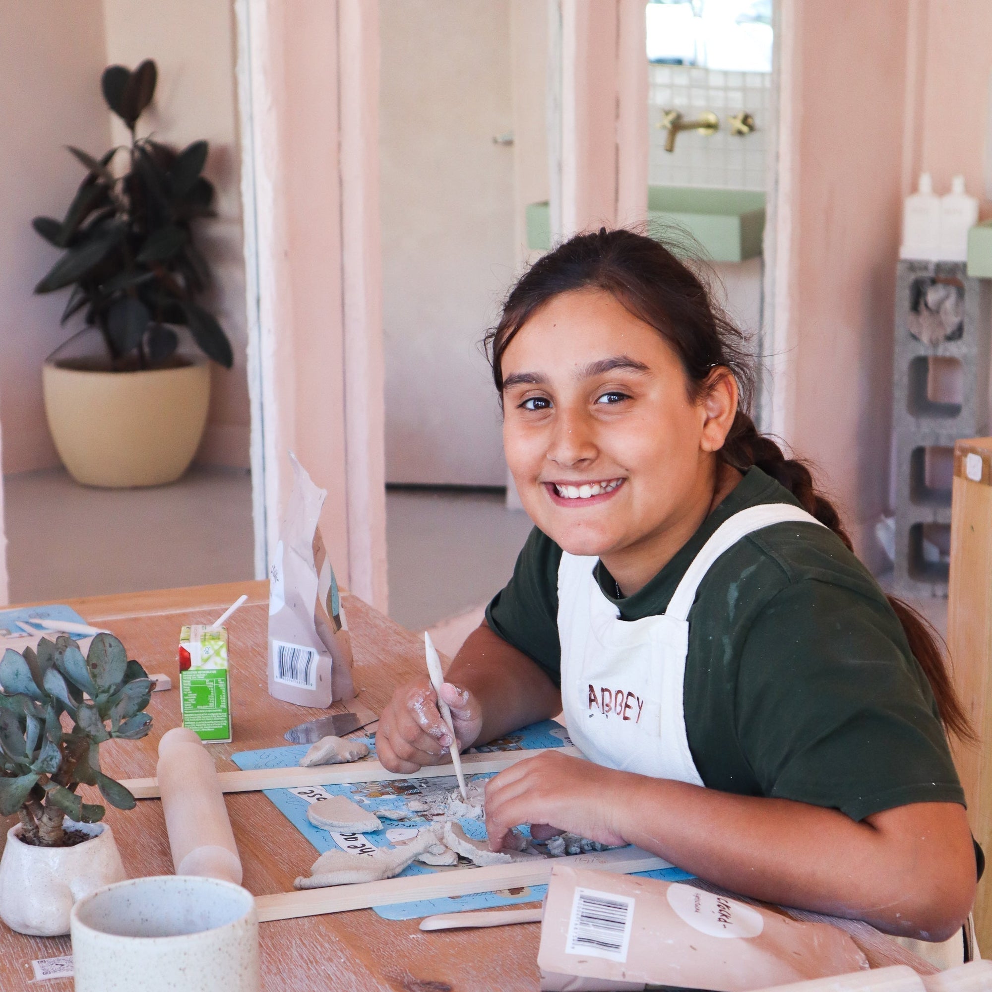 Group photo of children with their pottery creations