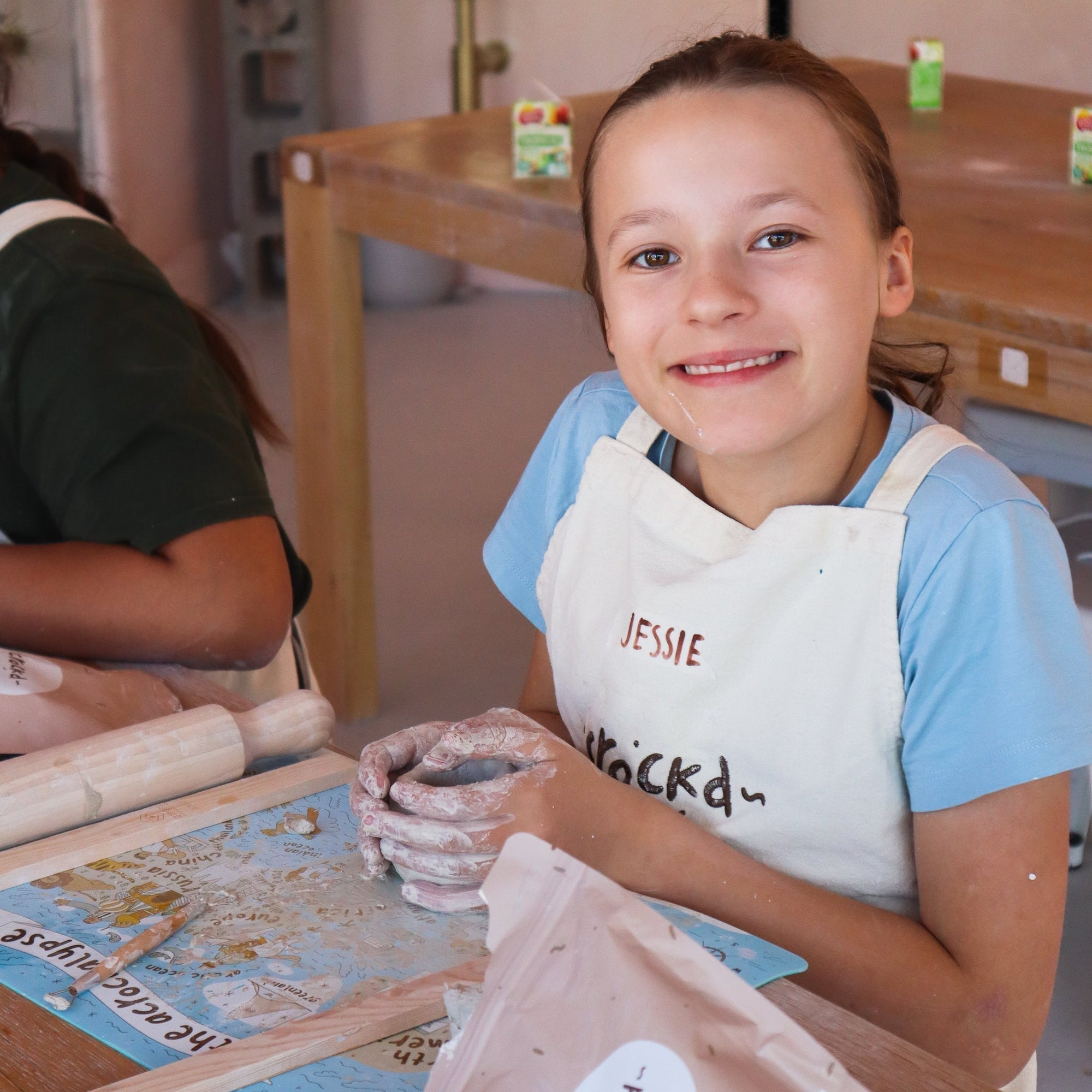 Kids engaged in various clay-building activities