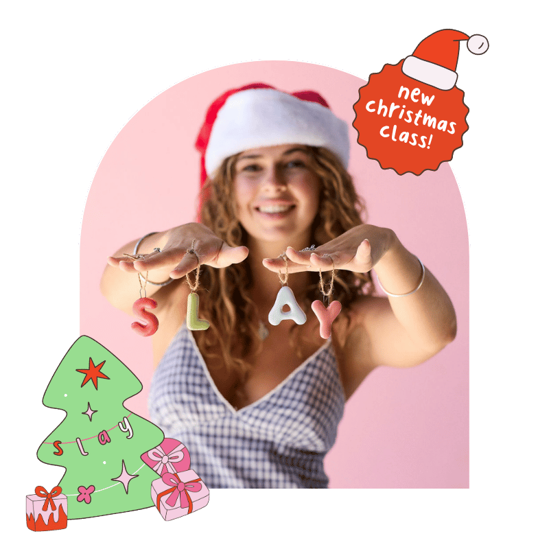 Woman wearing a Santa hat with Christmas-themed decorations and text on a pink background
