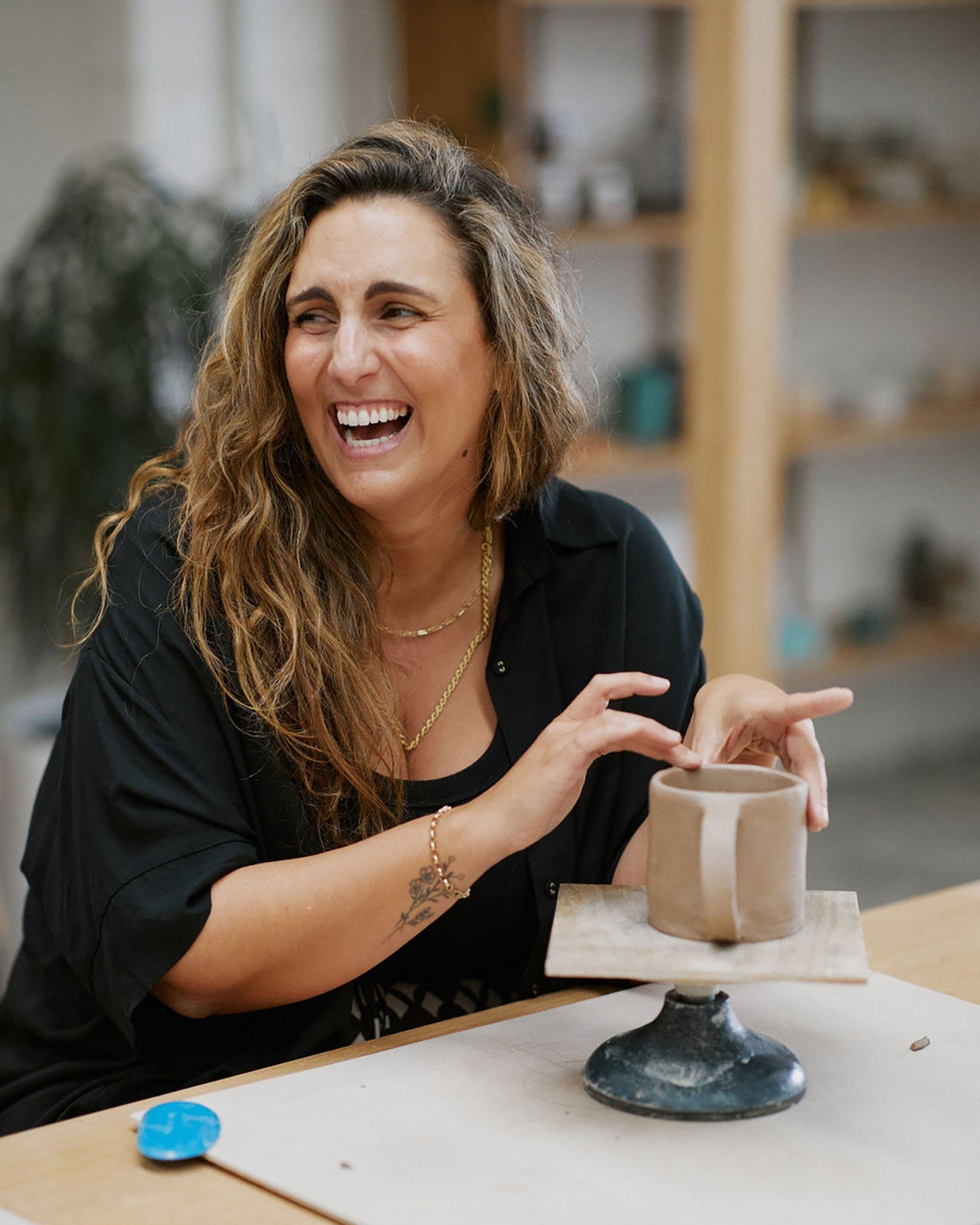 Instructor demonstrating mug shaping techniques