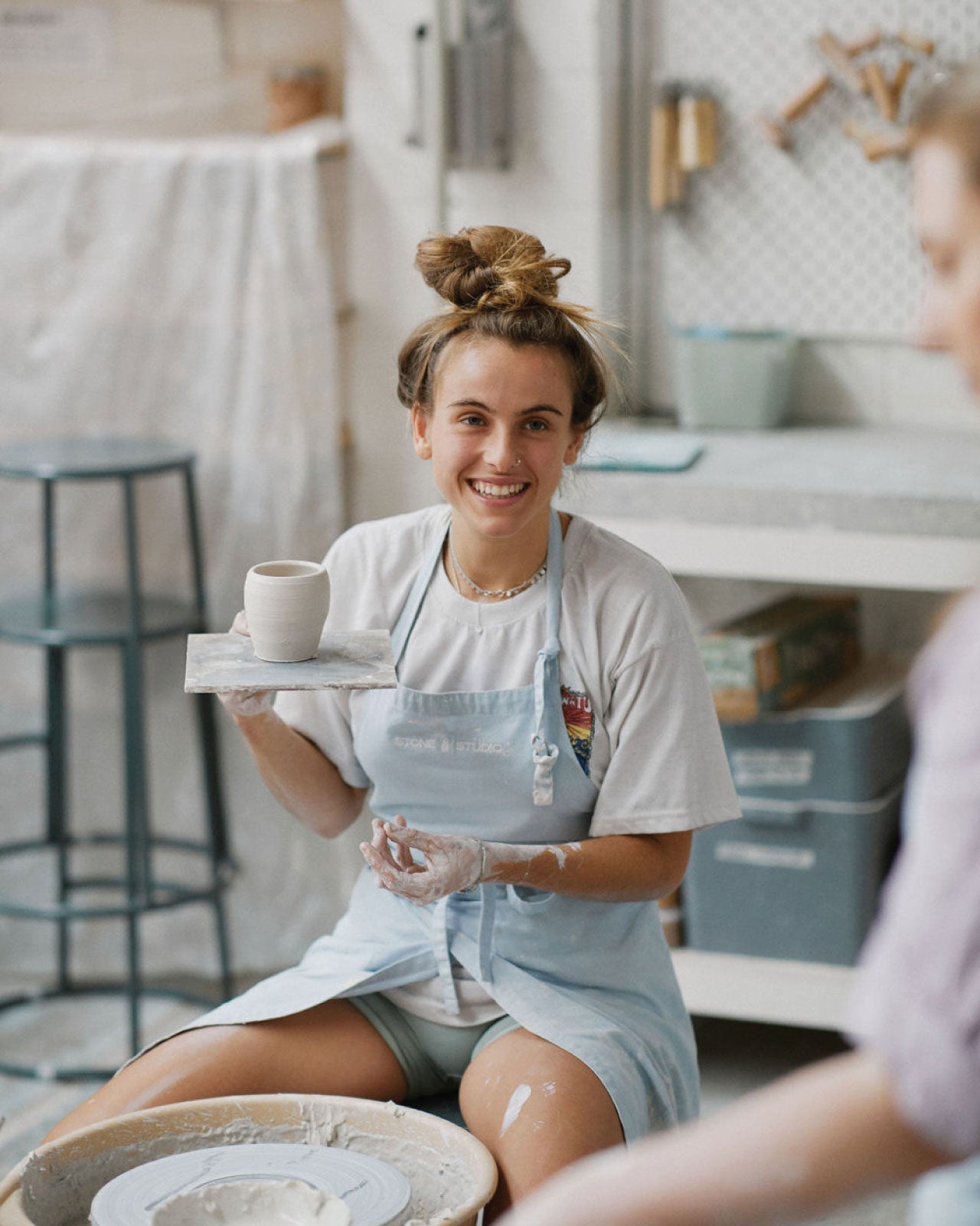 Students practicing glazing techniques on thrown pieces