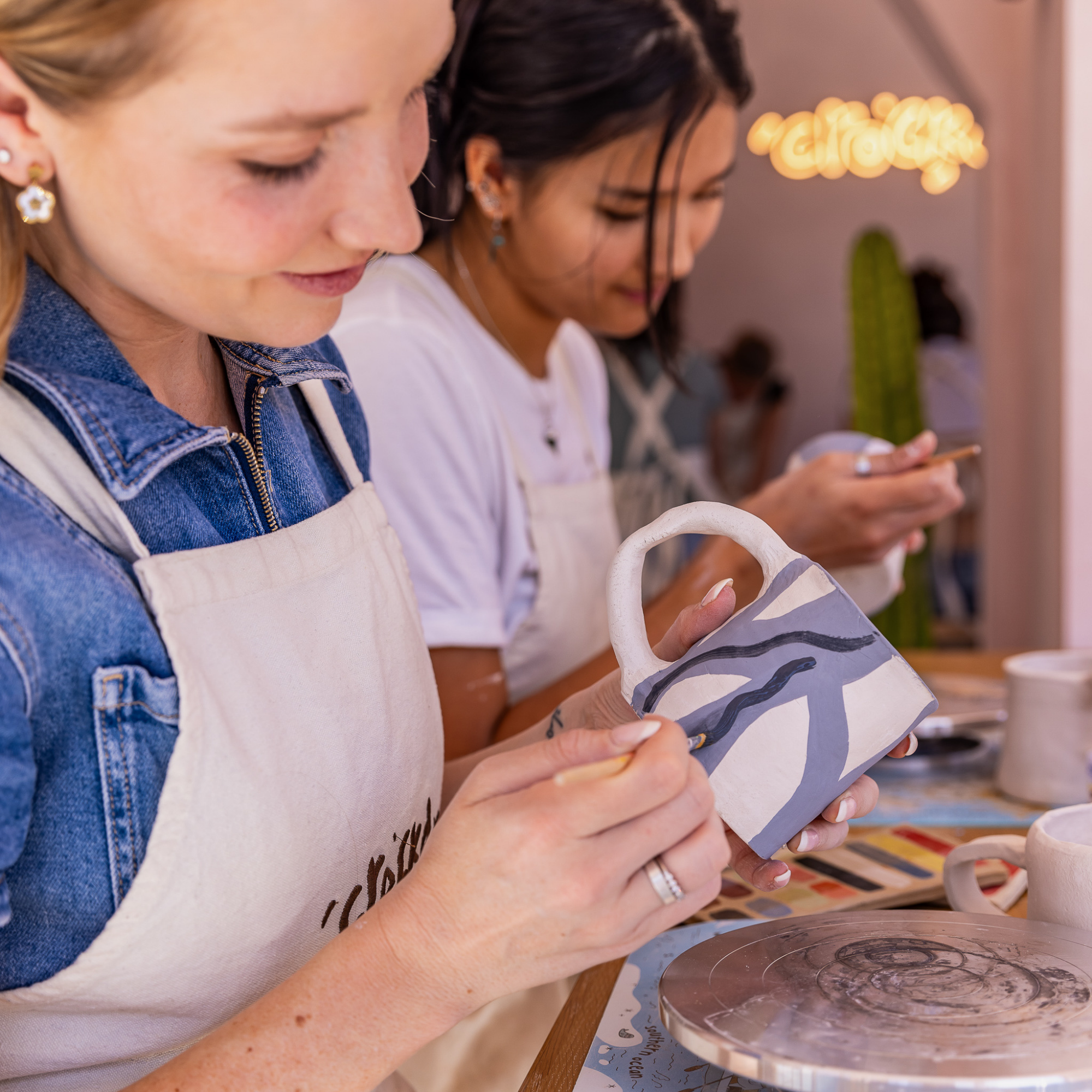 Participant selecting pottery piece to paint