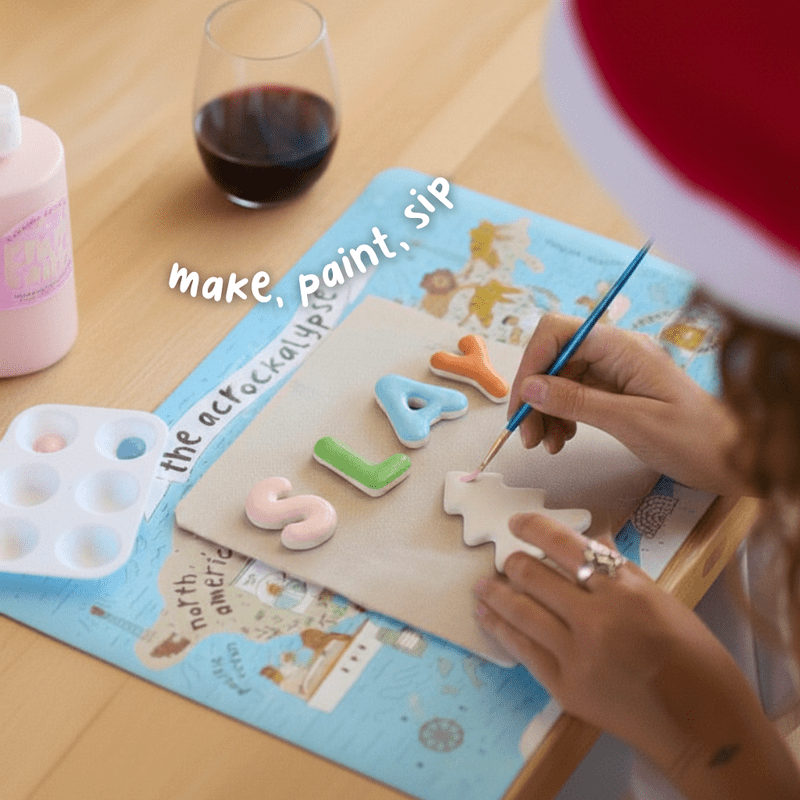 People making and painting handmade ceramic Christmas ornaments during a pottery workshop.