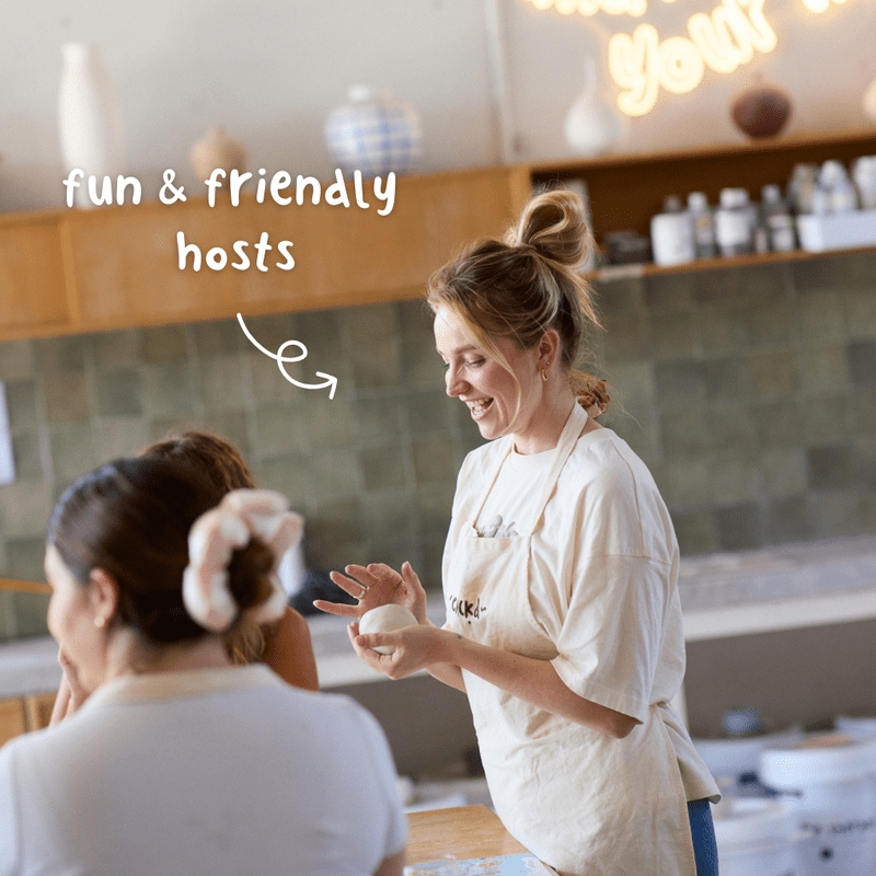 People making and painting handmade ceramic Christmas ornaments during a pottery workshop.