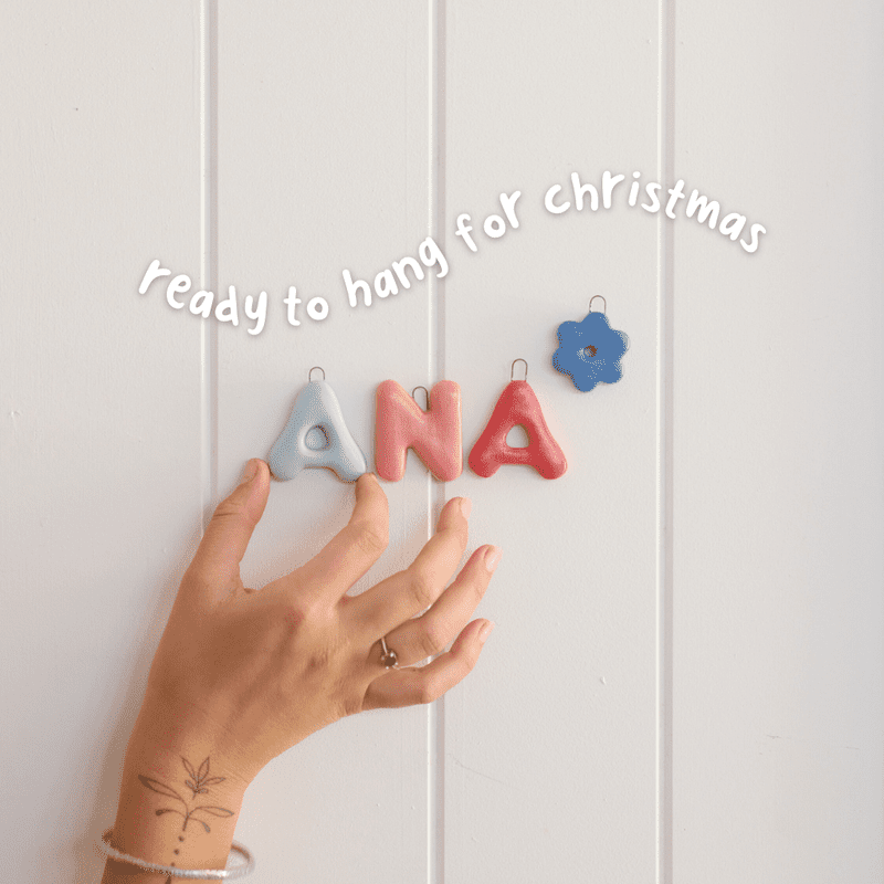 People making and painting handmade ceramic Christmas ornaments during a pottery workshop.