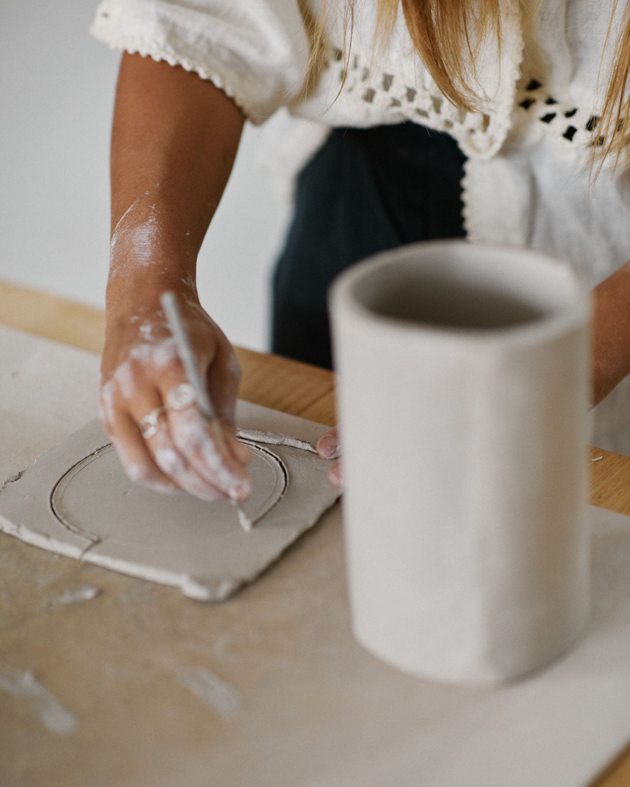 Various stages of vase creation and decoration