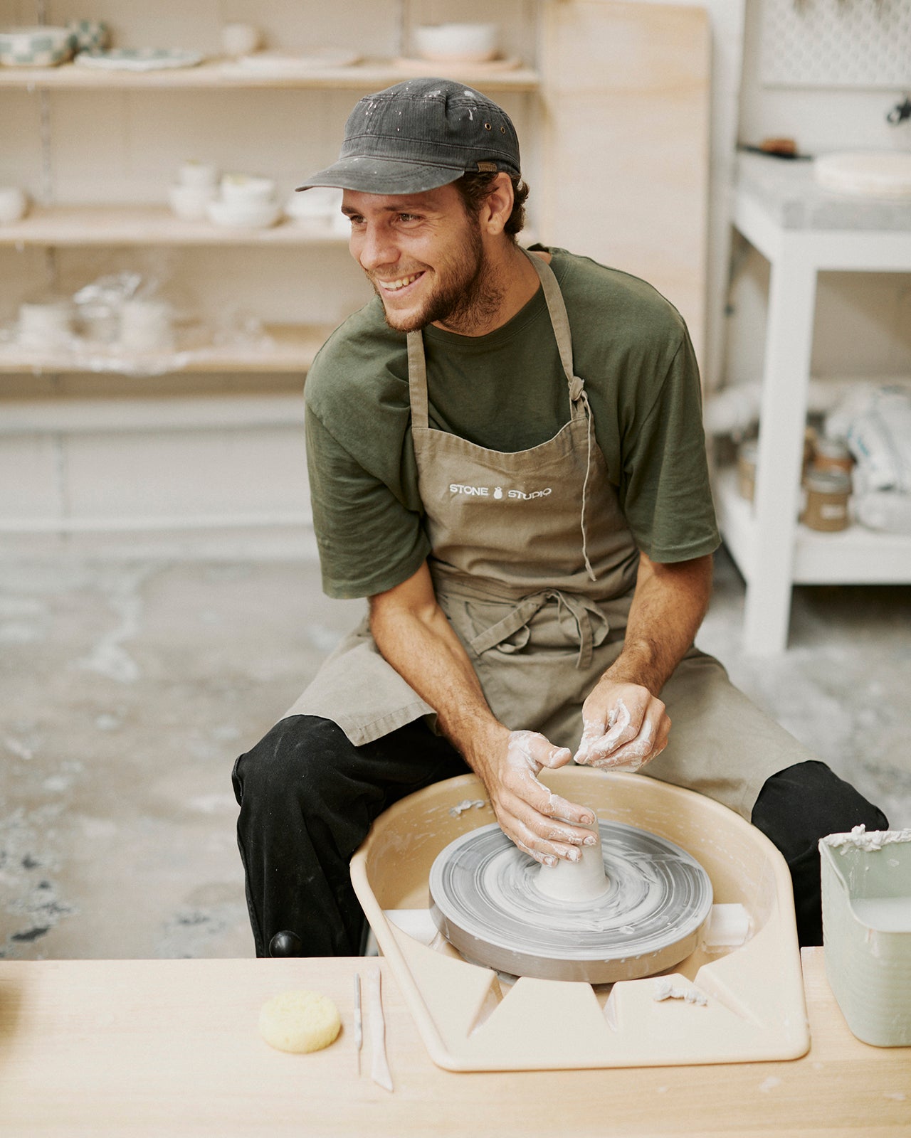 Instructor guiding couple through pottery techniques