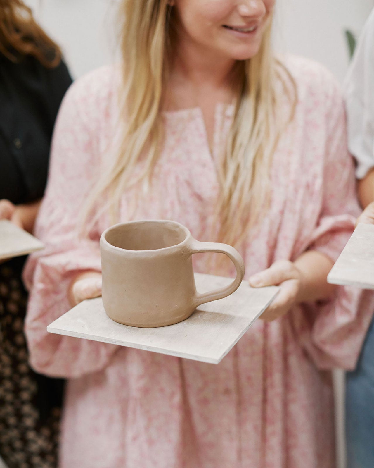 Variety of student-made mugs in different styles