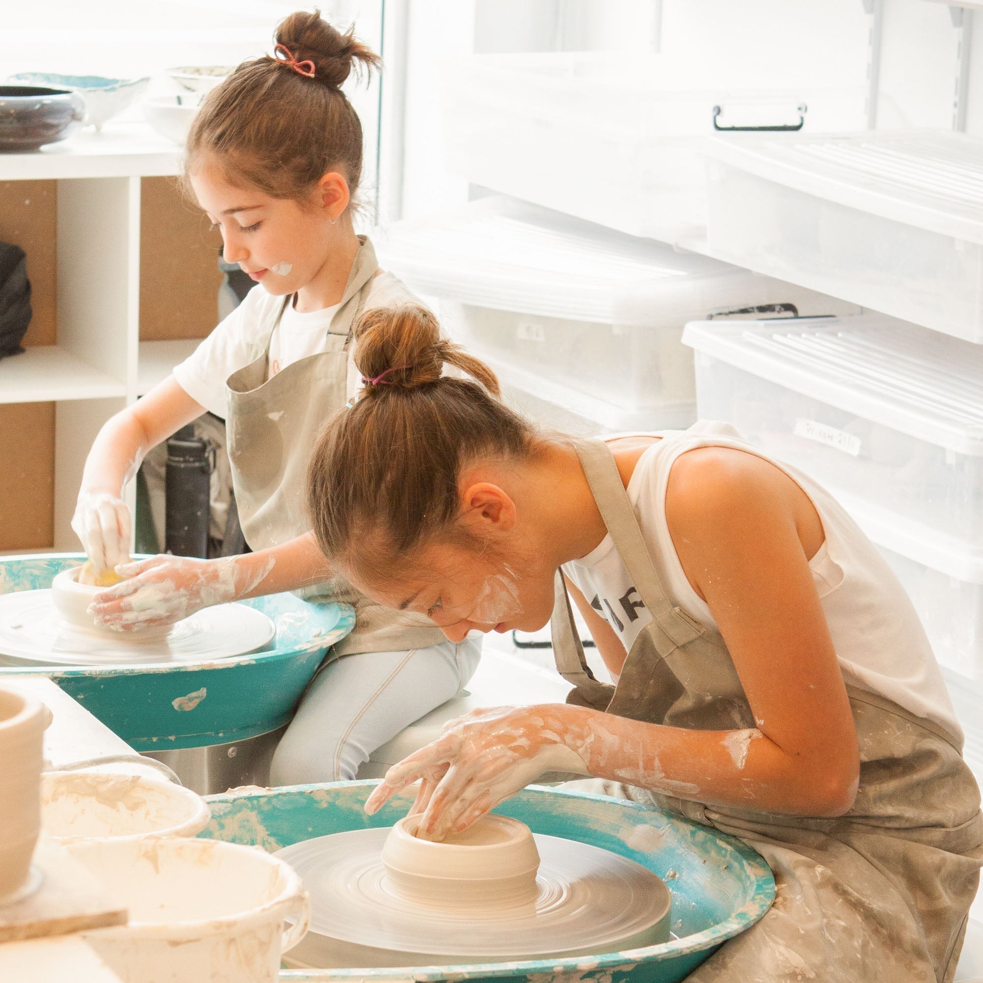 Multi-generational family enjoying pottery class together