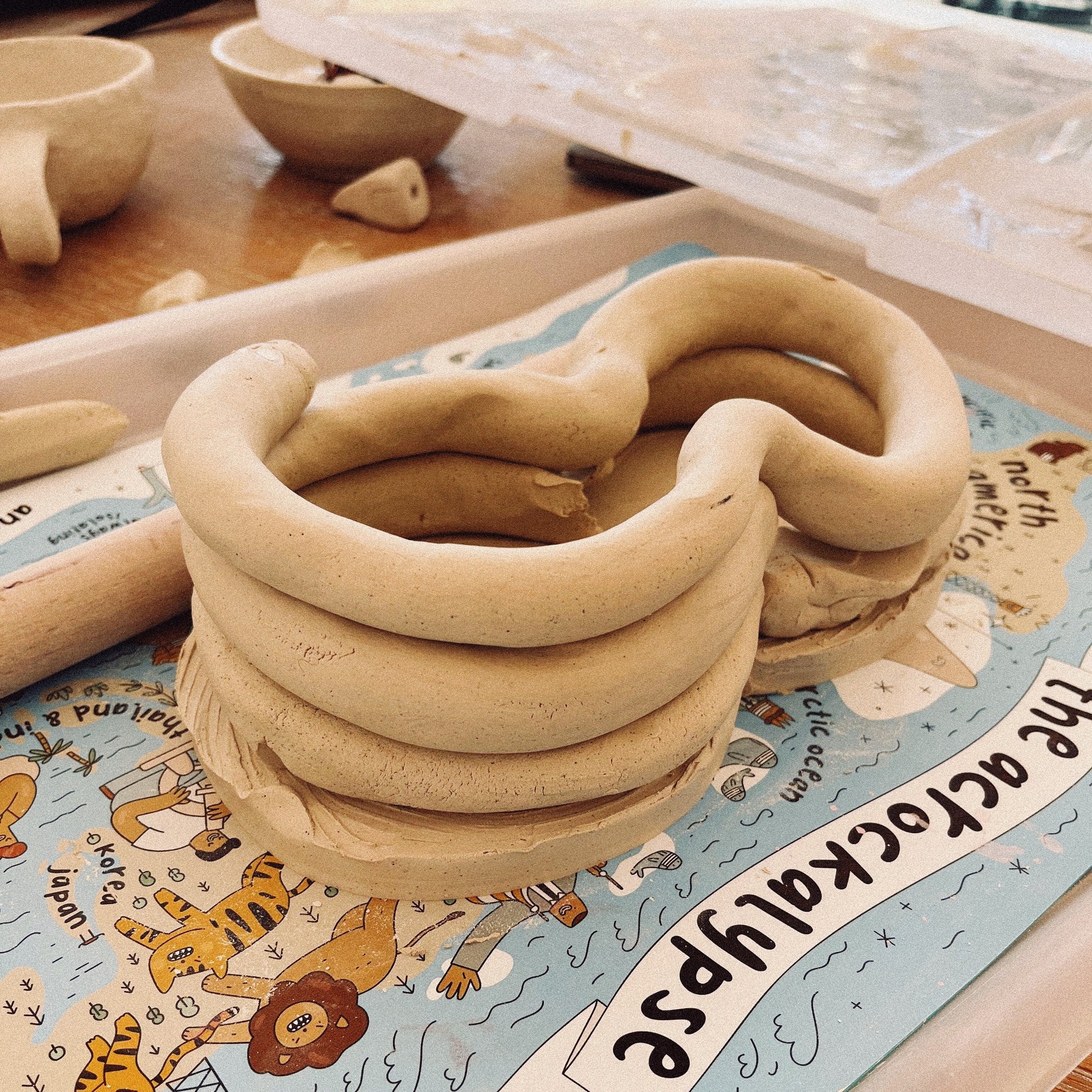 Students working on large-scale clay sculptures